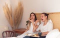 Young couple in the morning having romantic breakfast in bed in Valentines day as happy relationships Royalty Free Stock Photo