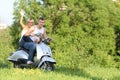 Young couple on motorbike / scooter on nature Royalty Free Stock Photo