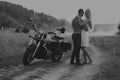 Young couple on a motorcycle in the field