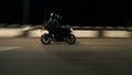 Young couple of motorcyclists riding on a night road.