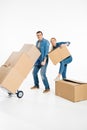 Young couple moving cardboard boxes with trolley cart Royalty Free Stock Photo