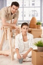 Young couple moving home boxes around smiling Royalty Free Stock Photo