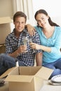 Young Couple Moving Into New Home Celebrating With Champagne Royalty Free Stock Photo