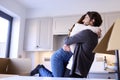 Young Couple Moving Into New Home Hugging As They Unpack Boxes In Kitchen Together Royalty Free Stock Photo