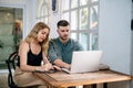 Young couple moving in new home. Sitting and relaxing after unpacking. Searching home decorating ideas on laptop. The concept of Royalty Free Stock Photo