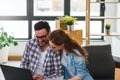 Ung couple moving in new home. Sitting and relaxing after unpacking. Looking something on laptop Royalty Free Stock Photo