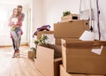 Young couple moving in new home. Unpacking box containers and cleaning. Royalty Free Stock Photo