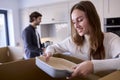 Young Couple Moving Into New Home Unpacking Boxes In Kitchen Together Royalty Free Stock Photo