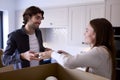 Young Couple Moving Into New Home Unpacking Boxes In Kitchen Together Royalty Free Stock Photo