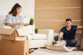 Young couple Moving in new home and unpacking carboard boxes