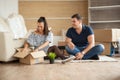 Young couple moving in a new home.