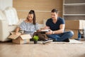 Young couple moving in a new home.