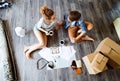 Young couple moving in new house, drinking coffee. Royalty Free Stock Photo