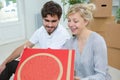 young couple moving in new house eating pizza Royalty Free Stock Photo