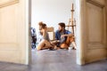 Young couple moving in new house, resting. Royalty Free Stock Photo