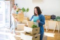 Young couple moving to new apartment, beautiful woman moving cardboard boxes and smiling happy