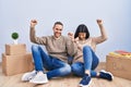 Young couple moving to a new home dancing happy and cheerful, smiling moving casual and confident listening to music Royalty Free Stock Photo