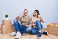 Young couple moving to a new home doing happy thumbs up gesture with hand Royalty Free Stock Photo