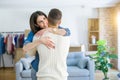 Young couple moving to a new home, hugging in love showing keys of new apartment smiling very happy Royalty Free Stock Photo