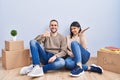 Young couple moving to a new home showing palm hand and doing ok gesture with thumbs up, smiling happy and cheerful Royalty Free Stock Photo