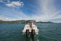 Young couple navigating on a yacht in Indian ocean. Handsome man and woman on deck of yacht lie on soft chair. Royalty Free Stock Photo