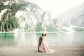 Young couple near a beautiful lake in the mountains. Lovers love one another close and smile