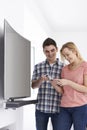 Young Couple With New Curved Screen Television At Home Royalty Free Stock Photo