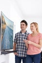 Young Couple With New Curved Screen Television At Home Royalty Free Stock Photo