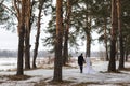 Young couple newlyweds go away in the winter forest in the snow