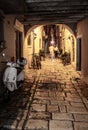 Young Couple In Narrow Alley With Bicycles And Motorbike In The Old Town Of The City Of Rovinj In Croatia Royalty Free Stock Photo