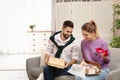 Young couple opening parcels on sofa Royalty Free Stock Photo
