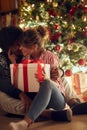 Young couple opening a present on a Christmas Royalty Free Stock Photo