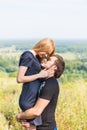 Young couple outdoor portrait. Beautiful pretty girl kissing handsome boy. Sensual photo Royalty Free Stock Photo