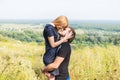 Young couple outdoor portrait. Beautiful pretty girl kissing handsome boy. Sensual photo Royalty Free Stock Photo