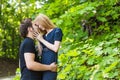 Young couple outdoor portrait. Beautiful pretty girl kissing handsome boy. Sensual photo Royalty Free Stock Photo