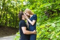 Young couple outdoor portrait. Beautiful pretty girl kissing handsome boy. Sensual photo Royalty Free Stock Photo