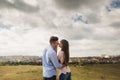 Young couple outdoor portrait. Beautiful pretty girl kissing handsome boy. Sensual photo Royalty Free Stock Photo
