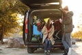 Young couple packing camping equipment into car trunk Royalty Free Stock Photo