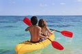 Young couple paddles their kayak