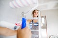 Young couple painting walls in their new house. Royalty Free Stock Photo