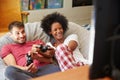 Young Couple In Pajamas Playing Video Game Together Royalty Free Stock Photo