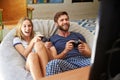 Young Couple In Pajamas Playing Video Game Together Royalty Free Stock Photo