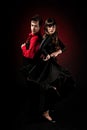 Young couple passion flamenco dancing on red light