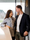 Couple at reception counter in hotel. Young couple on a business trip doing check-in at the hotel Royalty Free Stock Photo