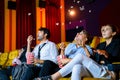 Young couple people watching movie feeling scary and frightening at movie theater. In hand holding snack bucket and throw popcorn Royalty Free Stock Photo