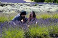 Young couple picking lavender in farm in Sequim, Washington on sunny summer day.