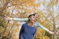 Young couple piggyback in park Royalty Free Stock Photo