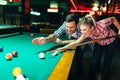 Young couple playing snooker together in bar Royalty Free Stock Photo