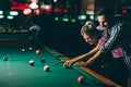 Young couple playing snooker together in bar Royalty Free Stock Photo