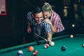 Young couple playing snooker together in bar Royalty Free Stock Photo